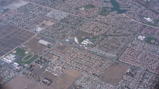 WA007_037 - 4K stock footage aerial video of a reverse view of lake and suburban homes in Moreno Valley, California