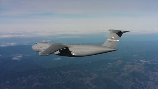 4K stock footage aerial video of revealing a Lockheed C-5 flying near mountains in Northern California Aerial Stock Footage | WAAF01_C036_0117T7