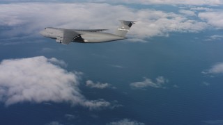 4K stock footage aerial video of a Lockheed C-5 firing flares over the ocean in Northern California Aerial Stock Footage | WAAF01_C045_0117KS