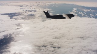 4K stock footage aerial video of a Lockheed C-5 firing flares over cloud cover in Northern California Aerial Stock Footage | WAAF01_C046_011778