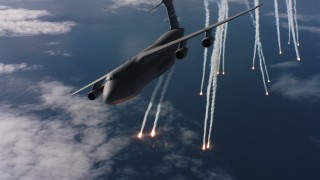 4K stock footage aerial video of passing a Lockheed C-5 dropping flares over the ocean in Northern California Aerial Stock Footage | WAAF01_C050_0117XT