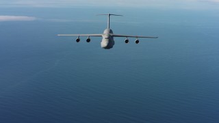 4K stock footage aerial video of a reverse view of a Lockheed C-5 flying over the ocean in Northern California Aerial Stock Footage | WAAF01_C066_01178K