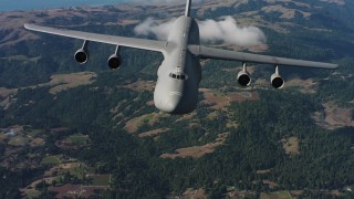 4K stock footage aerial video tilt from hills to reveal a Lockheed C-5 in Northern California Aerial Stock Footage | WAAF01_C069_0117TJ