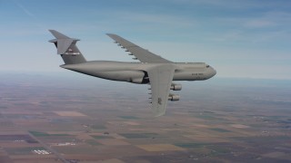 4K stock footage aerial video of a Lockheed C-5 in flight over farmland in Northern California Aerial Stock Footage | WAAF01_C078_0117MA