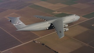 4K stock footage aerial video of a Lockheed C-5 in flight over farm fields in Northern California Aerial Stock Footage | WAAF01_C079_0117FV