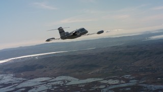 4K stock footage aerial video of a Learjet C-21 flying over marshland in Northern California Aerial Stock Footage | WAAF02_C003_0117QG