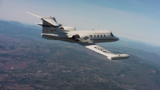 4K stock footage aerial video of a Learjet C-21 in flight over hills of Northern California Aerial Stock Footage | WAAF02_C004_0117QQ