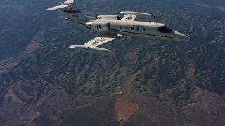 4K stock footage aerial video of a Learjet C-21 as it leaves frame, Northern California Aerial Stock Footage | WAAF02_C013_01176E