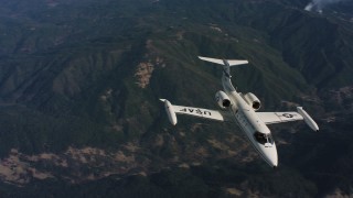 4K aerial stock footage video of tracking a Learjet C-21 in flight over mountains in Northern California Aerial Stock Footage | WAAF02_C020_0117TR