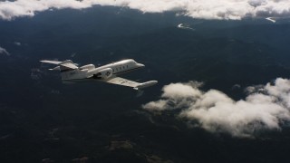 4K stock footage aerial video of flying around the tail end of a Learjet C-21 as it flies toward the Pacific Ocean in Northern California Aerial Stock Footage | WAAF02_C029_0117CV_S000