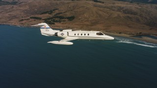 4K stock footage aerial video of a Learjet C-21 as it follows the coast in Northern California Aerial Stock Footage | WAAF02_C035_0117QK