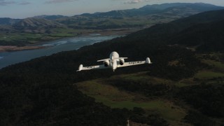 4K stock footage aerial video reveal a Learjet C-21 while flying over hills on the coast in Northern California Aerial Stock Footage | WAAF02_C040_0117KA