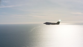 4K stock footage aerial video of revealing a Learjet C-21 flying by the Pacific Ocean in Northern California Aerial Stock Footage | WAAF02_C049_0117MK