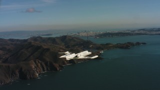 WAAF02_C051_01170K - 4K stock footage aerial video of a Learjet C-21 flying by Marin Hills and reveal San Francisco, California