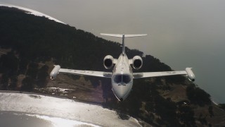 4K stock footage aerial video a reverse view of a Learjet C-21 flying over a bay in Northern California Aerial Stock Footage | WAAF02_C056_011763