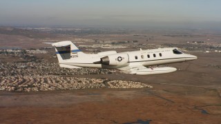 4K stock footage aerial video of a Learjet C-21 flying near homes and marshland in Northern California Aerial Stock Footage | WAAF02_C062_0117QX