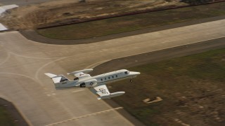 WAAF02_C066_0117D0 - 4K stock footage aerial video of a Learjet C-21 landing at Travis Air Force Base, California