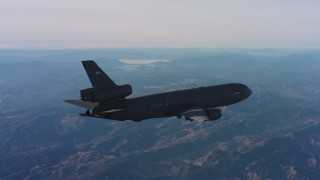 4K stock footage aerial video of revealing a McDonnell Douglas KC-10 flying over hills in Northern California Aerial Stock Footage | WAAF03_C012_0118D4