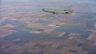 4K stock footage aerial video of flying around the tail of a McDonnell Douglas KC-10 over farmland in Northern California Aerial Stock Footage | WAAF03_C015_01181L