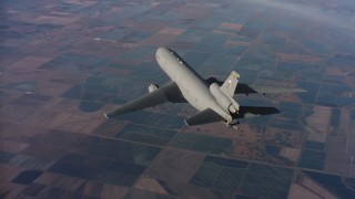 4K stock footage aerial video of flying around the tail of a McDonnell Douglas KC-10 over farms in Northern California Aerial Stock Footage | WAAF03_C017_01180A