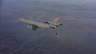 WAAF03_C023_0118T3 - 4K stock footage aerial video of a McDonnell Douglas KC-10 lowering refueling boom as it flies over hills, Northern California