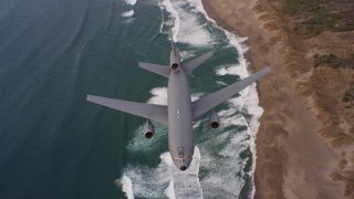 4K stock footage aerial video of a reverse view of a McDonnell Douglas KC-10 flying over beaches in Northern California Aerial Stock Footage | WAAF03_C055_01189Q