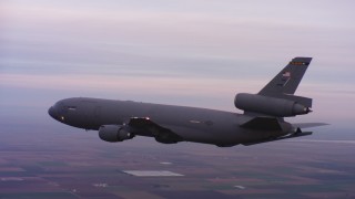 4K stock footage aerial video of a McDonnell Douglas KC-10 flying over farms at sunset in Northern California Aerial Stock Footage | WAAF03_C069_01185P