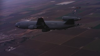 4K stock footage aerial video of a McDonnell Douglas KC-10 in flight over farmland at sunset in Northern California Aerial Stock Footage | WAAF03_C070_0118QG