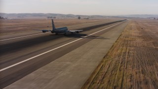 WAAF04_C007_01187P - 4K stock footage aerial video of a Boeing KC-135 lifting off from Travis Air Force Base, California