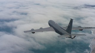 WAAF04_C070_0118HE_S000 - 4K stock footage aerial video of a Boeing KC-135 flying over clouds on the coast in Northern California