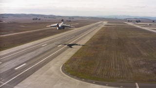 WAAF05_C001_0118DL - 4K aerial stock footage video of a Boeing C-17 lifting off from Travis Air Force Base, California