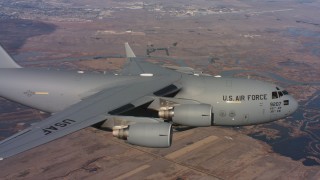 WAAF05_C004_0118EU - 4K stock footage aerial video of a Boeing C-17 flying over wetlands in Northern California