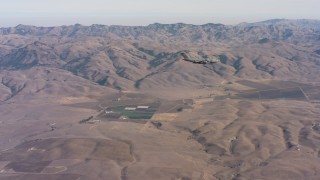 WAAF05_C027_0118X7 - 4K stock footage aerial video of a Boeing C-17 flying near mountains in Northern California