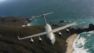 WAAF05_C040_0118VW - 4K stock footage aerial video of a Boeing C-17 following the coastline of Northern California