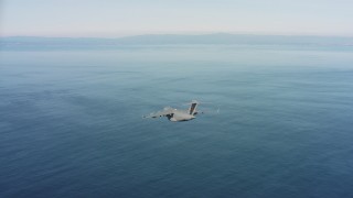 WAAF05_C048_0118M5 - 4K stock footage aerial video of a Boeing C-17 flying over the ocean in Northern California 