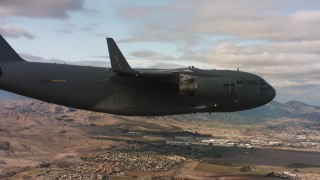 WAAF05_C072_0118KB - 4K stock footage aerial video of a Boeing C-17 flying over residential neighborhoods in Northern California