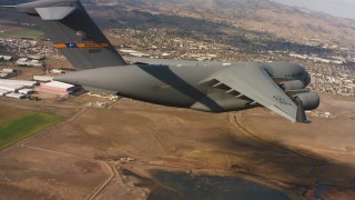 4K stock footage aerial video of a Boeing C-17 in flight near neighborhoods in Northern California Aerial Stock Footage | WAAF05_C074_01187N