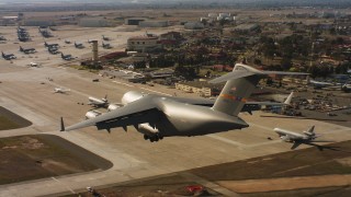 WAAF05_C080_0118FB - 4K aerial stock footage video of a Boeing C-17 landing at Travis Air Force Base, California