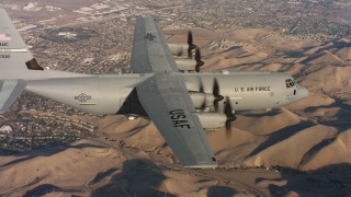 4K stock footage aerial video of a Lockheed Martin C-130J flying near neighborhoods at sunset in Northern California Aerial Stock Footage | WAAF06_C010_0119DW