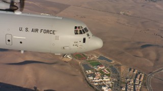 4K stock footage aerial video of the nose and cockpit section of a Lockheed Martin C-130J flying at sunset in Northern California Aerial Stock Footage | WAAF06_C014_01194G