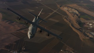 4K stock footage aerial video of flying around the front end of a Lockheed Martin C-130J at sunset, Northern California Aerial Stock Footage | WAAF06_C026_0119G8