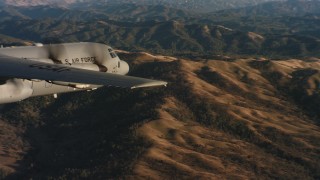 4K stock footage aerial video of revealing a Lockheed Martin C-130J flying over mountains at sunset in Northern California Aerial Stock Footage | WAAF06_C028_0119QR