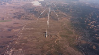 4K stock footage aerial video of a reverse view of a Lockheed Martin C-130J shooting flares at sunset, Northern California Aerial Stock Footage | WAAF06_C046_0119RB