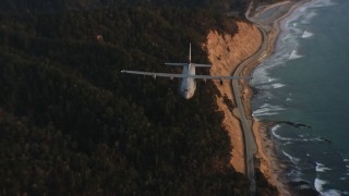 4K stock footage aerial video of a Lockheed Martin C-130J following the coast at sunset in Northern California Aerial Stock Footage | WAAF06_C072_01194X