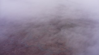 4K stock footage aerial video of a reverse view of misty clouds over marshland in Northern California Aerial Stock Footage | WAAF07_C002_011982