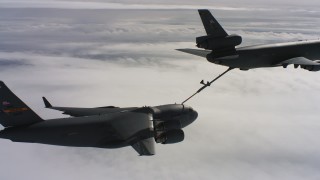 4K stock footage aerial video of a McDonnell Douglas KC-10 fueling a Boeing C-17 above clouds in Northern California Aerial Stock Footage | WAAF07_C051_0119AJ