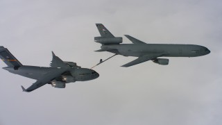 WAAF07_C061_0119HM - 4K stock footage aerial video of a McDonnell Douglas KC-10 fueling a Boeing C-17 and retracting boom in Northern California