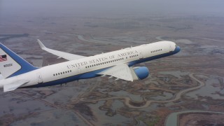 4K stock footage aerial video of revealing a Boeing C-32 flying over wetlands in Northern California Aerial Stock Footage | WAAF08_C006_0119WU