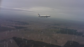 4K stock footage aerial video of tracking a Boeing C-32 over windmills in Northern California Aerial Stock Footage | WAAF08_C008_0119F0