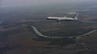 4K stock footage aerial video approach and fly over a Boeing C-32 in flight over Northern California Aerial Stock Footage | WAAF08_C011_011950